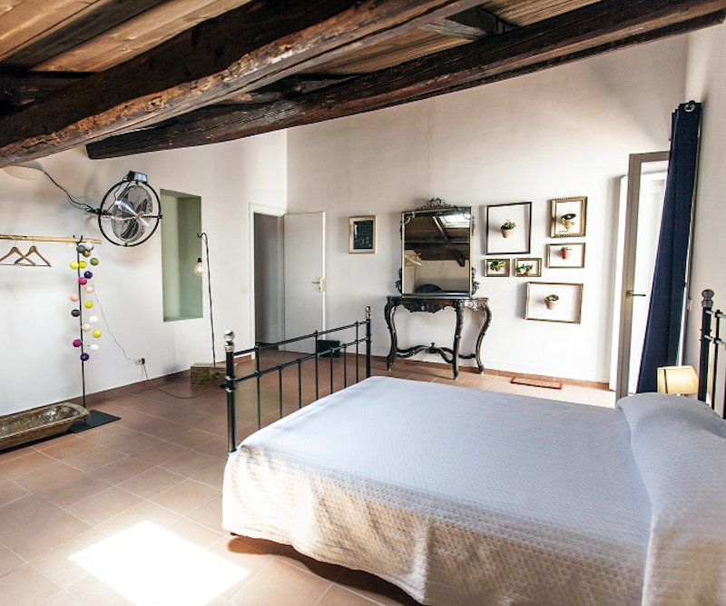 Charming bedroom with exposed wooden beams at The Church B&B Naples